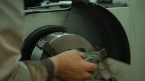 Factory worker cleans equipment with a dirty rag Stock Footage 122245920