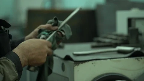 Factory worker cleans his tools with a dirty rag Stock Footage 122244487