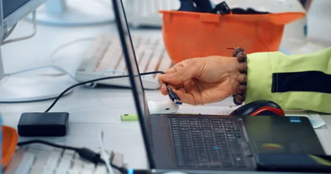 A factory worker connects an external hard drive to his laptop via USB  Stock Footage 147634070