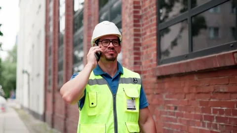 Factory Worker On Construction Site Talking On Phone Stock Footage 313364311