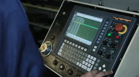 A factory worker at controls of machine with numerical control Stock Footage 64560763