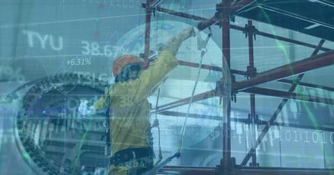 Factory worker in coverall adjusting harness tether on red scaffolding in plant Stock Photos