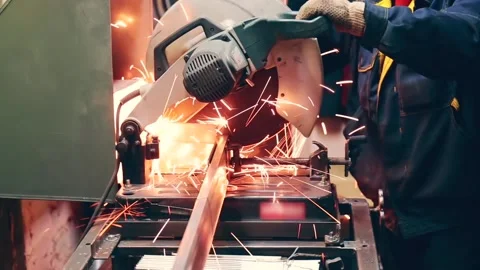 Factory worker cuts metal or steel with compound mitre saw circular blade with Video stock 150357569