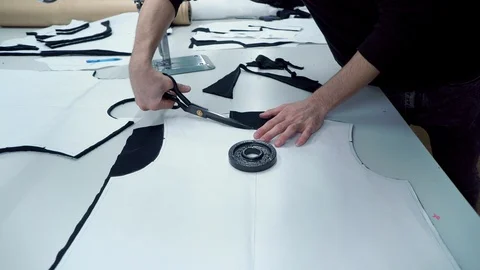 Factory worker cuts the workpiece pattern clothes scissors Stock Footage 104323564
