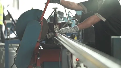 Factory Worker Cutting Aluminum Duct Pipes On Machine With Sparks Stock Footage 79083105