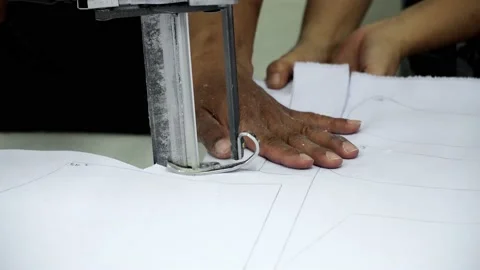 Factory worker cutting of fabric in factory. Used the razor machine for cutti Stock Footage 166045377