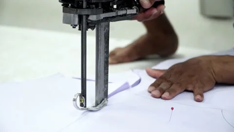 Factory worker cutting of fabric in factory. Used the razor machine for cutti Stock Footage 166045448