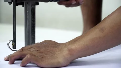 Factory worker cutting of fabric in factory. Used the razor machine for cutti Stock Footage 166045511