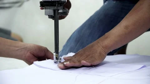Factory worker cutting of fabric in factory. Used the razor machine for cutti Stock Footage 166045571