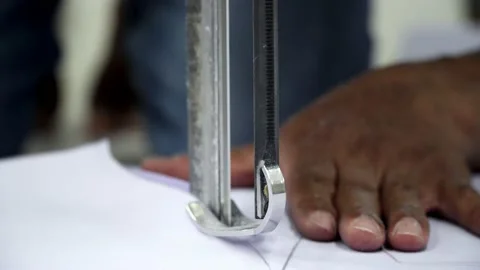 Factory worker cutting of fabric in factory. Used the razor machine for cutti Stock Footage 166045593
