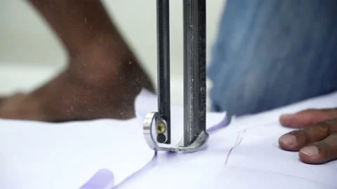 Factory worker cutting of fabric in factory. Used the razor machine for cutti Stock Footage 166045707