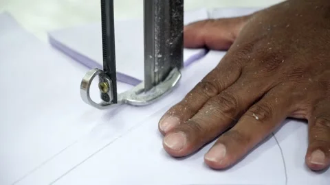 Factory worker cutting of fabric in factory. Used the razor machine for cutti Stock Footage 166045749