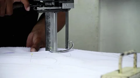 Factory worker cutting of fabric in factory. Used the razor machine for cutti Stock Footage 166045835