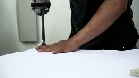 Factory worker cutting of fabric in factory. Used the razor machine for cutti Stock Footage 166045863