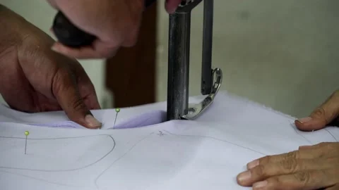 Factory worker cutting of fabric in factory. Used the razor machine for cutti Stock Footage 166045895