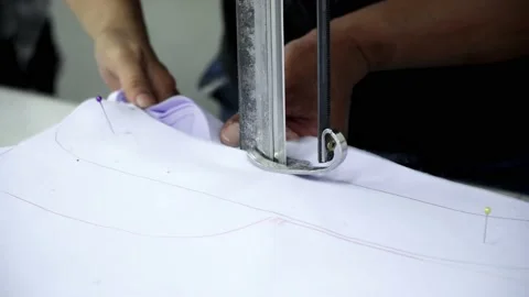 Factory worker cutting of fabric in factory. Used the razor machine for cutti Stock Footage 166045928