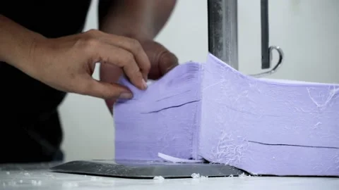 Factory worker cutting of fabric in factory. Used the razor machine for cutti Stock Footage 166045949