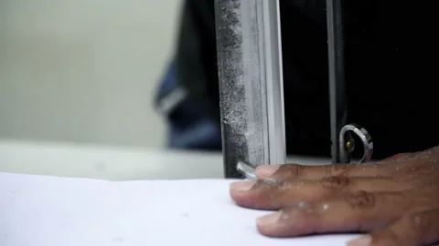 Factory worker cutting of fabric in factory. Used the razor machine for cutti Stock Footage 166046013