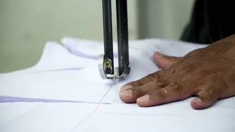 Factory worker cutting of fabric in factory. Used the razor machine for cutti Stock Footage 166046092