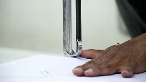 Factory worker cutting of fabric in factory. Used the razor machine for cutti Stock Footage 166046119