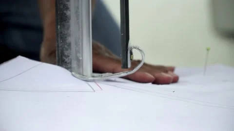 Factory worker cutting of fabric in factory. Used the razor machine for cutti Stock Footage 166046141