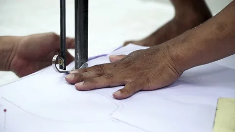 Factory worker cutting of fabric in factory. Used the razor machine for cutti Stock Footage 166046150