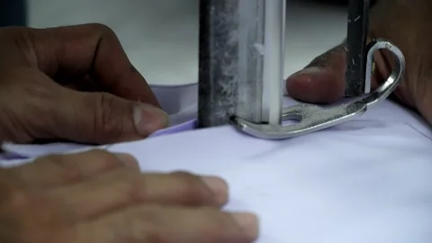 Factory worker cutting of fabric in factory. Used the razor machine for cutti Stock Footage 166046438