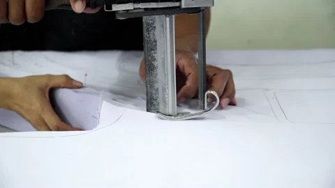 Factory worker cutting of fabric in factory. Used the razor machine for cutti Stock Footage 166046693