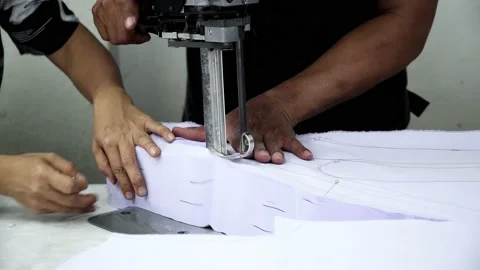 Factory worker cutting of fabric in factory. Used the razor machine for cutti Stock Footage 166046751