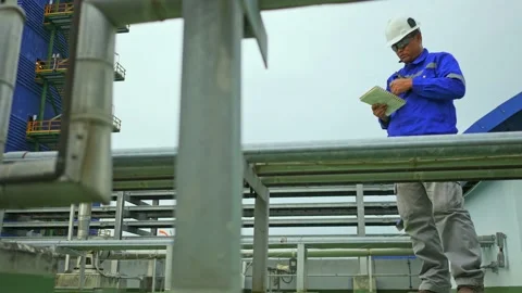 Factory worker to daily check equipment in factory and recort to note book Stock Footage 149590742