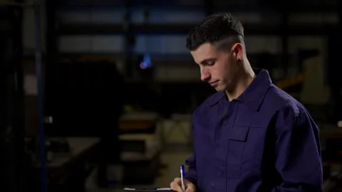 Factory worker doing inventory and looking at camera Stock Footage 267044737