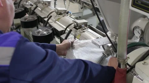 Factory worker fills a bag with polypropylene granules. barrel PP Pet Chips Semi Stock Footage 156049769