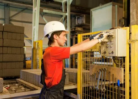 Factory worker fixing broken device.. Stock Photos
