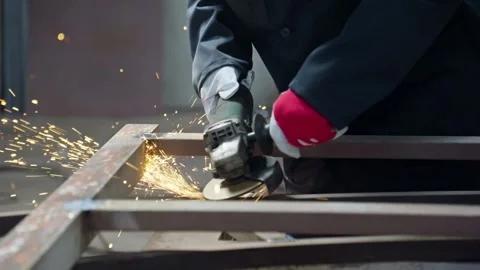 Factory worker grinding metal. Worker in protective clothing. Bright sparks Stock Footage 246637179