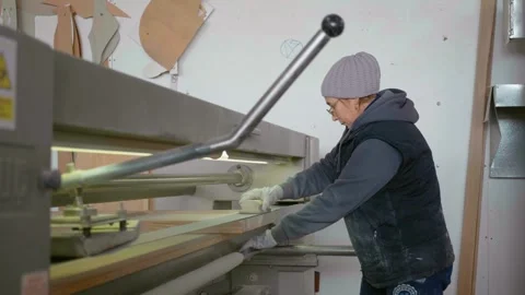 Factory worker inserts a new lock into the interior of doors. Stock Footage 296542194