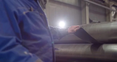 Factory Worker Inspecting Steel Wire Rope, Industrial Hall Interior, Medium Shot Stock Footage 340356260