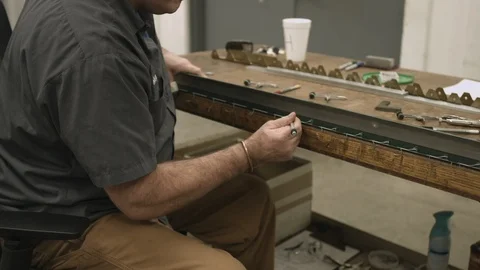 Factory worker inspects and marks metal component for processing slider Stock Footage 116176974
