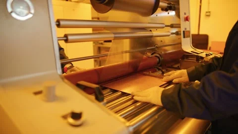 Factory worker laminating copper sheet with transparent film Stock Footage 316542890