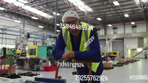 Factory worker leaning on hand truck, data overlays passing across torso, Stock Footage 334321953