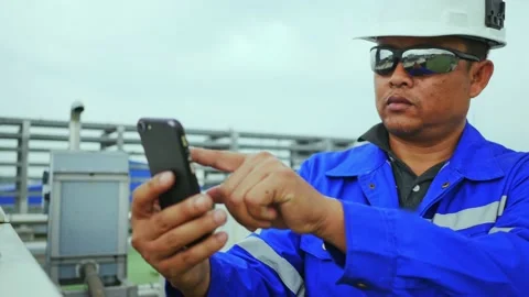 Factory worker look at mobile phones during their leisure time Stock Footage 149590367