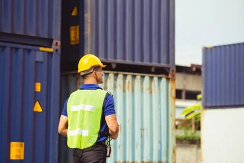Factory worker man checking containers box from cargo Stockfoto's