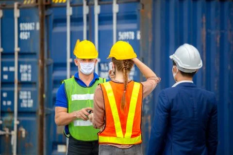 Factory worker man checking fever by digital thermometer for scan and protect 스톡 사진
