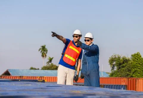 Factory worker man foreman checking control loading containers box from cargo 写真素材