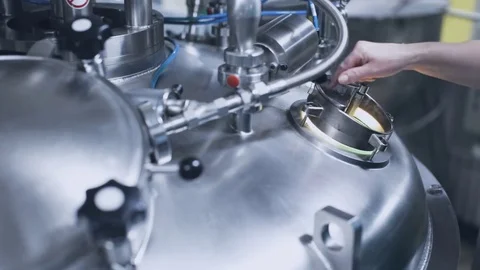 The factory worker opens the hatch of the tank Stock Footage 75222691