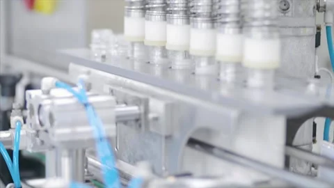 Factory worker operates bottling machinery on the production line. Stock Footage 159722682