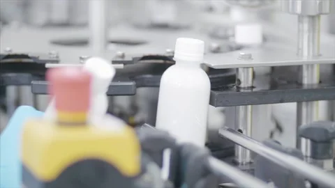 Factory worker operates bottling machinery on the production line. Stock Footage 159722700