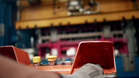Factory worker operating a big hydraulic press in a car part production Stock Footage 255220714
