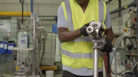 Factory Worker Operating Hose System for Coolant Transfer Stock Footage 336187264