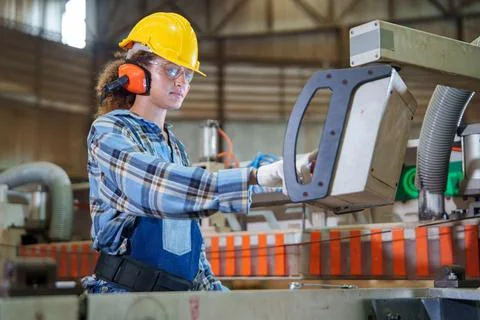 Factory worker operating industrial control equipment during production Stock Photos