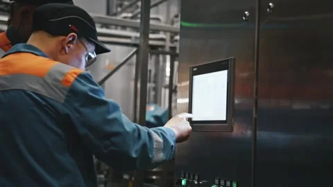 Factory worker operating industrial touch screen control panel Stock Footage 337411129